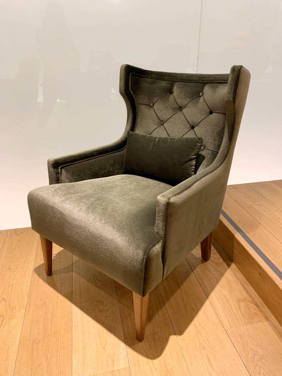 velvet rich green armchair with a green velvet pillow