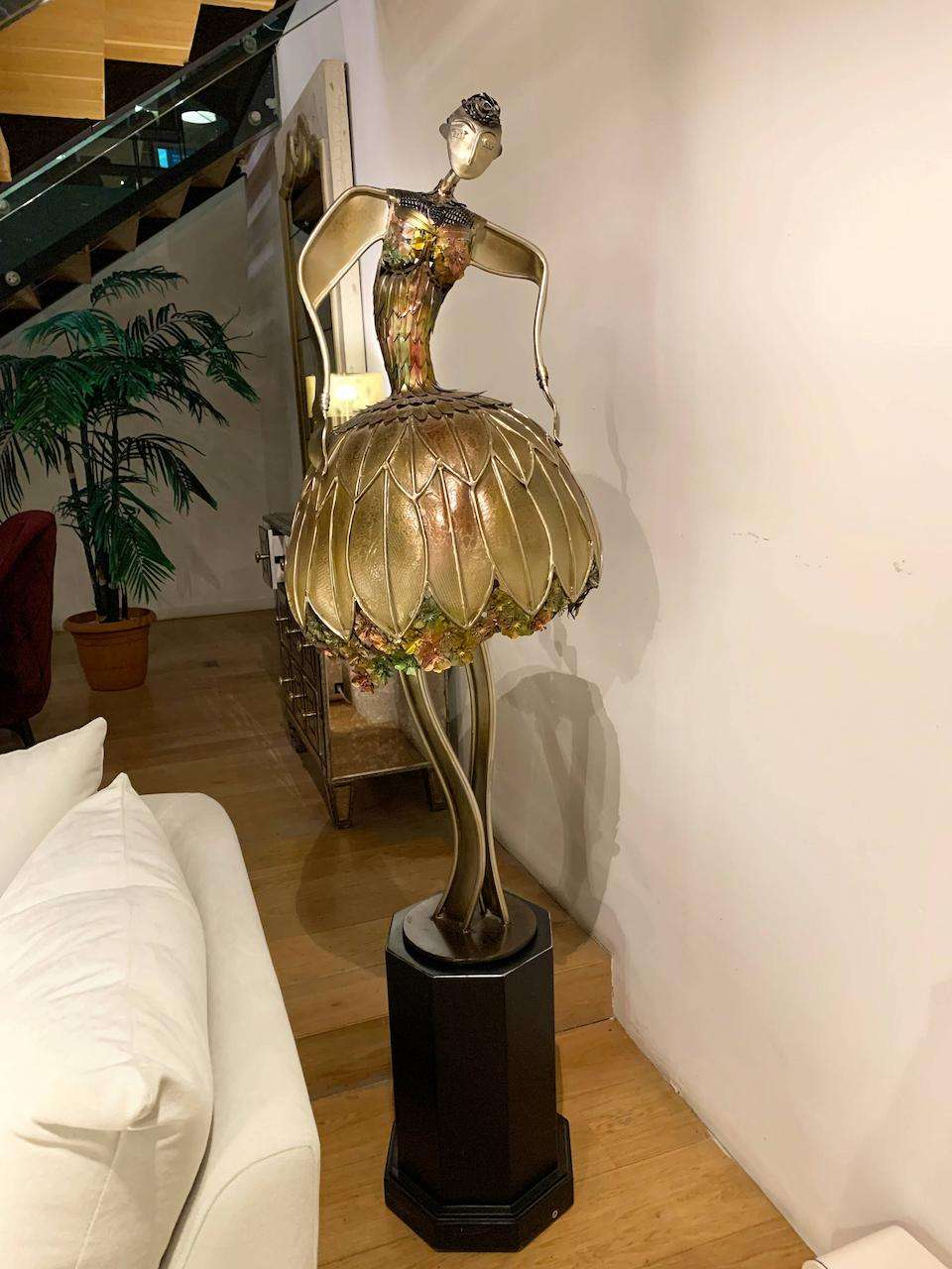 big golden lamp in the shape of a female ballerina