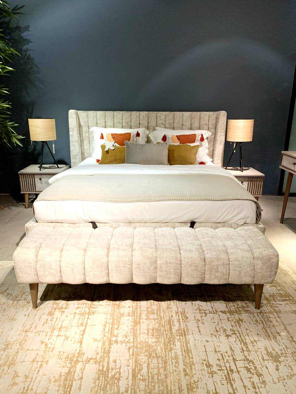 king sized light beige bed and ottoman