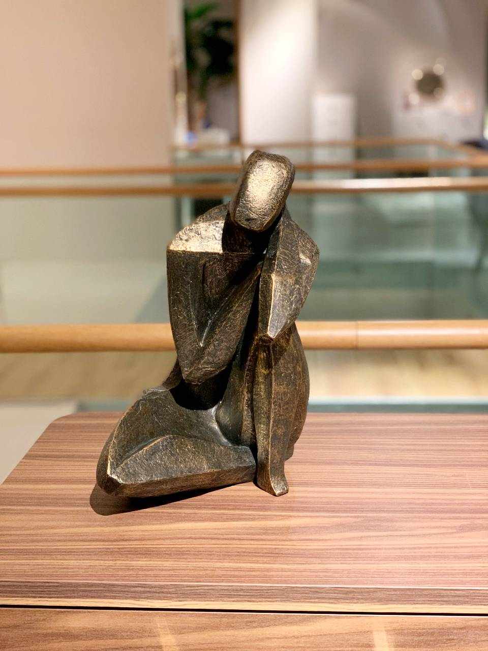 metallic sculpture of a person sitting