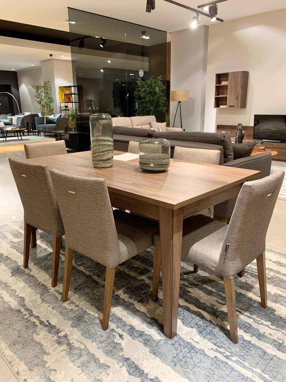 brown wooden dining table with sharp edges and four brown chairs